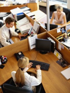 high angle view of a businessman and two businesswomen working in an office